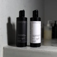 Meera Capsule Rebalancing Shampoo and Peptide Conditioning Cream — styled product shot of the duo bundle