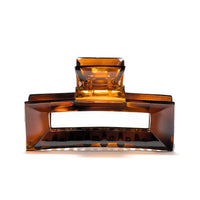 Frame 9 claw clip in Deep Amber — architectural tortoise-tone cellulose acetate hair clip, made in France