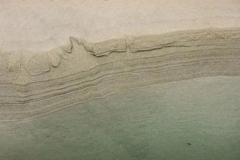Fine layers of sand shaped by the receding tide at the end of summer