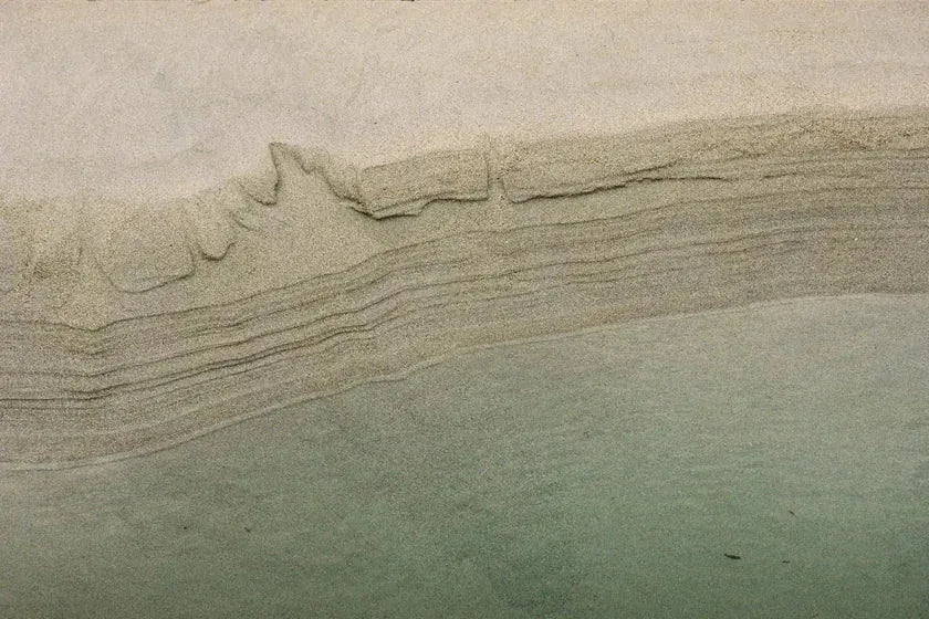 Fine layers of sand shaped by the receding tide at the end of summer