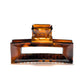Frame 9 claw clip in Deep Amber — architectural tortoise-tone cellulose acetate hair clip, made in France