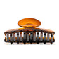Luna 9 Deep Amber claw clip detail — Meera Studio Line, rounded tortoise silhouette