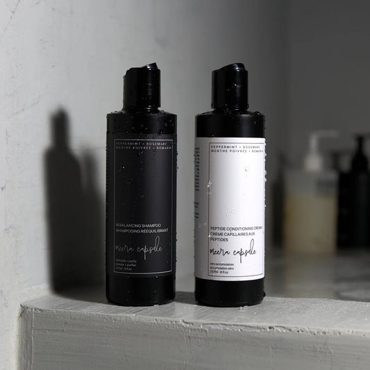 Meera Capsule Rebalancing Shampoo and Peptide Conditioning Cream — styled product shot of the duo bundle